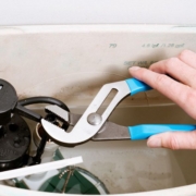 Why Does My Toilet Keep Running? | Superior Plumbing Plumber inspecting a running toilet and checking the tank components to identify the cause of continuous water flow | Why Does My Toilet Keep Running?